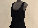 a mannequin wearing a black dress on a mannequin stand