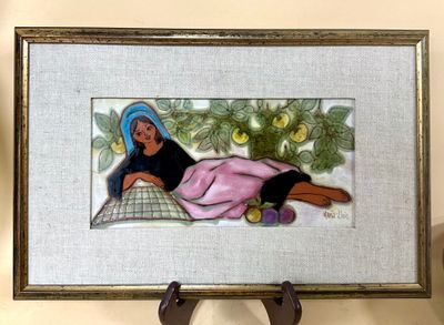 a picture of a woman laying on a pillow under a tree