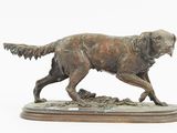 bronze statue of a dog on a wooden base on a white background