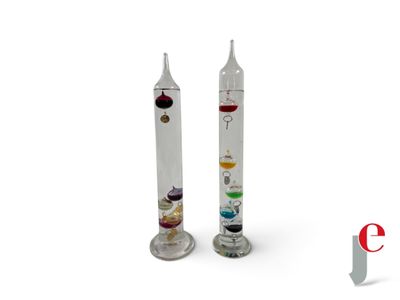 two glass candles that have different colored candles inside of them