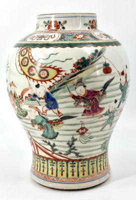 a vase with a painting on it sitting on a table