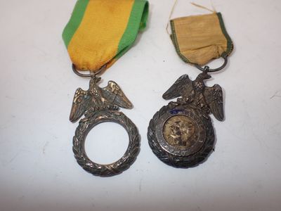 two medals and a medal on a white surface