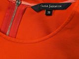 a close up of an orange shirt with a zipper on it
