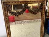 a mirror that is sitting on the floor in front of a chair