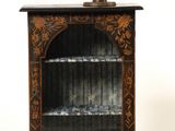 a small cabinet with a bust on top of it