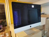 a computer monitor sitting on top of boxes in a room