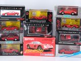 a lot of red toy cars in boxes on a white surface