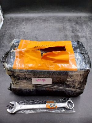 two wrenches and a bag on the back of a truck
