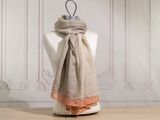 the scarf is hanging on a mannequin in front of a white wall