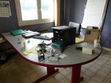 an image of a desk with a lot of clutter on it