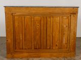 a wooden bar with a marble top on a tile floor