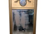 a mirror with a picture of a man standing in front of it