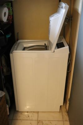a washing machine in the corner of a small room