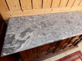 a marble counter top in a room with a rug on the floor
