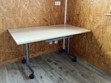 a white table with wheels in the corner of a room