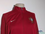 the jacket is red and white with a portugal crest on it