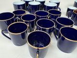 a lot of blue coffee mugs sitting on a table