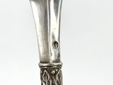 a silver candle holder with a candle on it