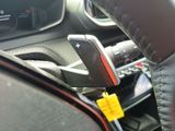 steering wheel of a car with a cell phone attached to it