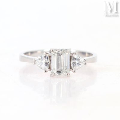 a close up view of a three stone engagement ring