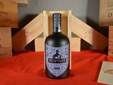 a bottle of wine sitting on a table with wooden crates