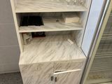 a marble display case in the corner of a bathroom