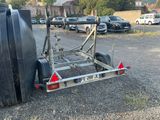 a small trailer with a water tank attached to it