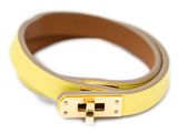 a close up of a yellow leather belt with a gold buckle