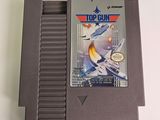 an old nintendo game cartridge with the top gun on top of it