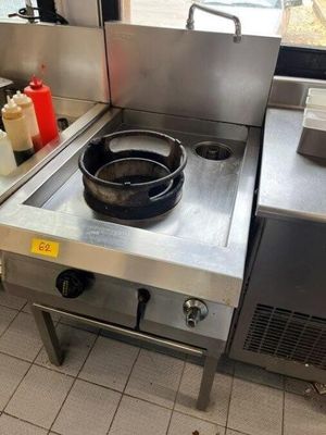 a frying pan on a stove in a restaurant kitchen