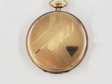 an image of a gold pocket watch sitting on a white surface