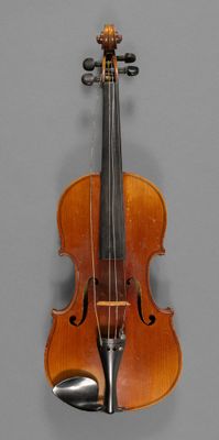 an old violin sitting on top of a table next to a wall