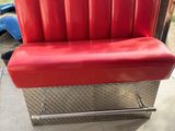 a red couch that is sitting on a metal bench