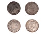 un ensemble de quatre pièces d'argent sur fond blanc