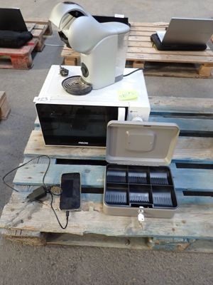 a microwave sitting on top of a pallet with a laptop on it