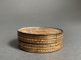 a close up of a stack of coins on a table