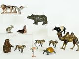 many figurines of animals on display on a white surface