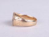 an image of a gold ring on a white surface