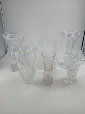 a lot of glass vases sitting on a table