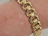 gold plated bracelet with a turtle design on the wrist
