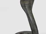 a close up of a statue of a cobra on a white background