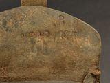 an old iron pot that is sitting on top of a table