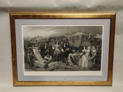 une vieille photo montrant un groupe de personnes réunies autour d'une table