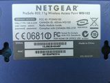 a label on the back of a laptop that says netgear