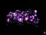 purple amethorate beads on a black background