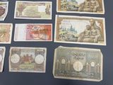 several different bank notes are laid out on a table