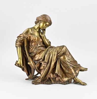 a bronze statue of a woman sitting on a chair with her hand on her chin