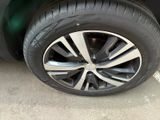 a close up of a tire on a car in a parking lot