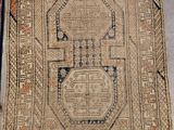 two rugs with designs on them sitting on a floor