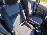 two seats in the back of a small van
